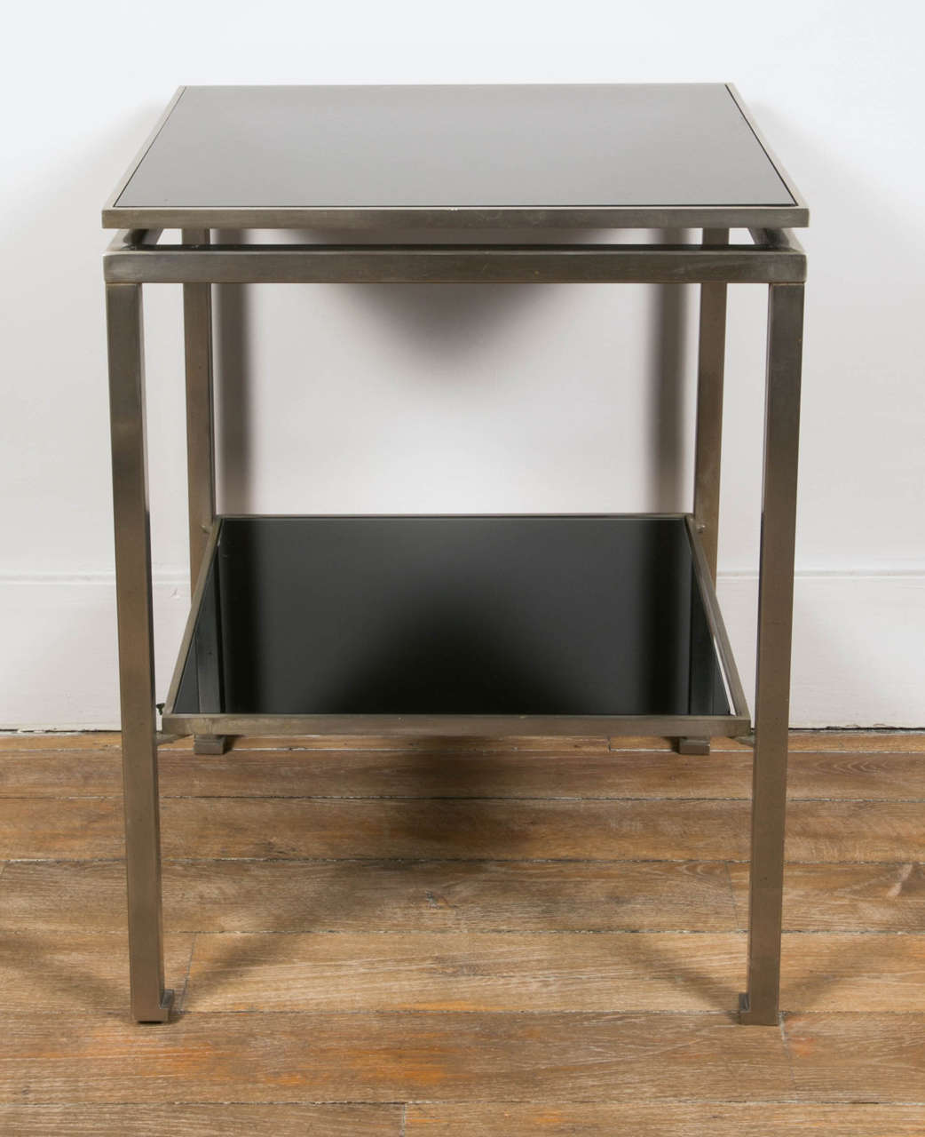 A pair of square two tiers tables , steel structure, black opaline tops. By Guy Lefevre.
