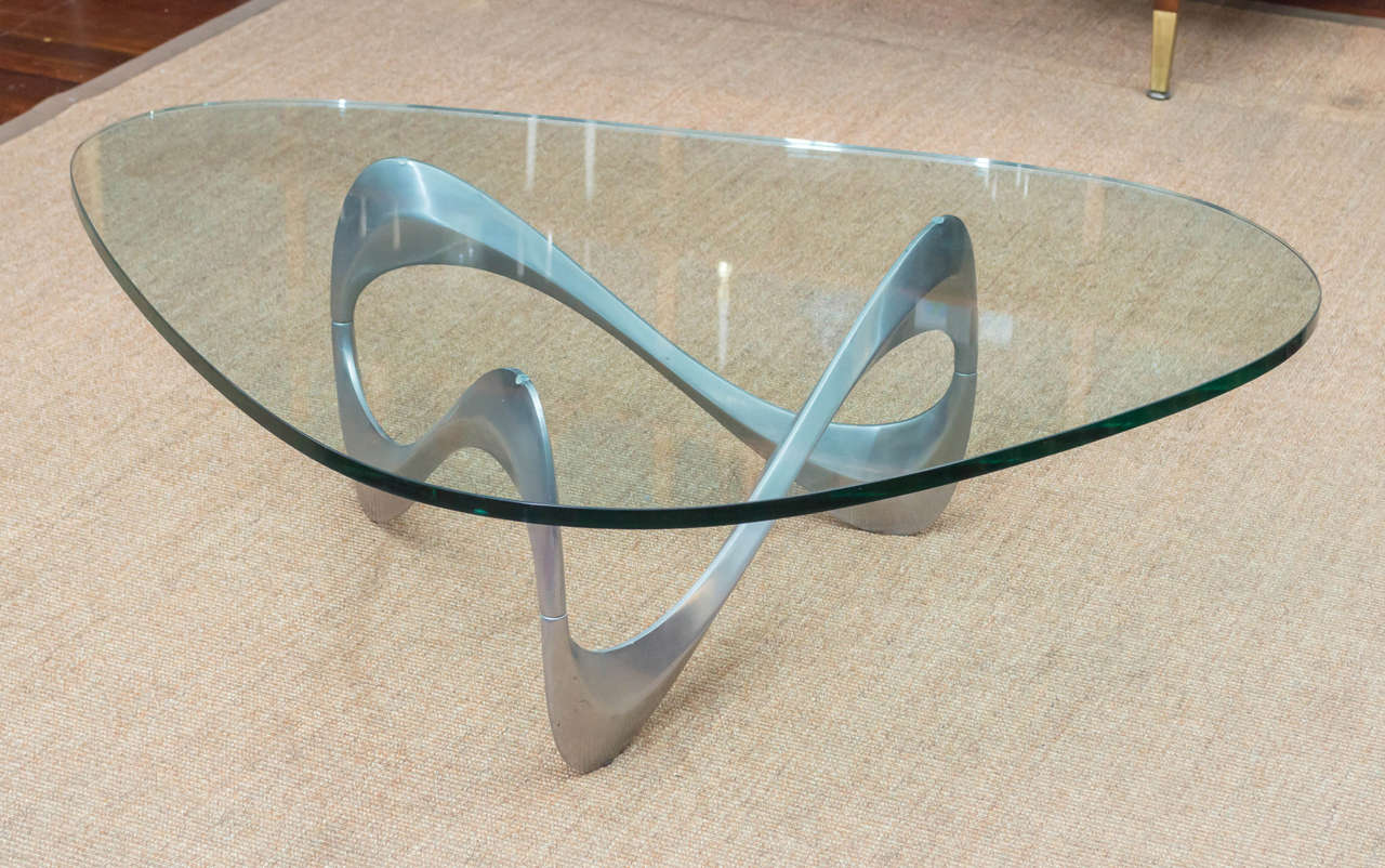 Sculptural cast aluminum coffee table by Knut Hesterberg, reminiscent of the infinity symbol. Very good vintage condition with a thick heavy glass top.