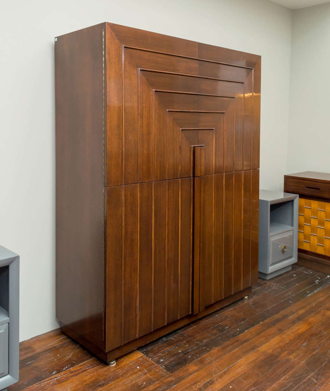 Rare and stunning T.H. Robsjohn-Gibbings design cabinet for Widdicomb Furniture Company.
Manufactured from walnut with four equal size symmetric doors it is the perfect storage cabinet for living or dining rooms.
Fitted interiors comprise nine