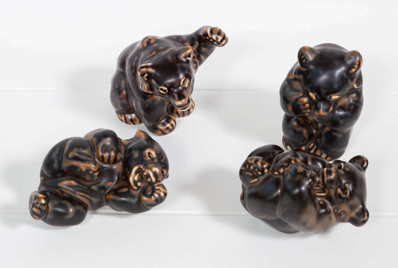 A playful set of Danish modern ceramic bears by Knud Kyhn for Royal Copenhagen. Maker's mark and signature on bottom.