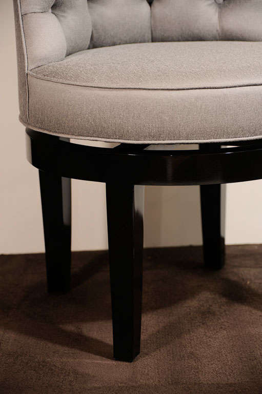 Elegant vanity stool has low back<br />
with tufted design, as well as a<br />
swivel seat.  The base and legs<br />
are in black lacquer.  Newly<br />
upholstered in platinum<br />
sharkskin.