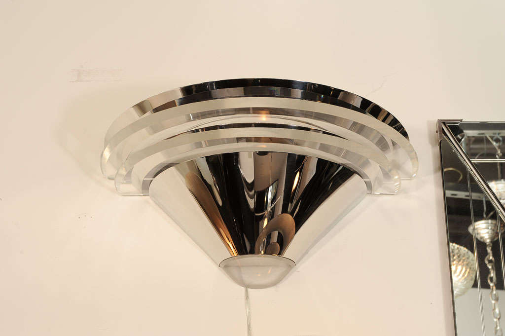 This pair of Mid-Century Modernist Saturn Sconces by Lorin Marsh suggests the curvilinear lines of Art Deco designs employing modern materials evocative of 1970s design. These materials- radiant polished chrome and crystalline lucite- magnify the