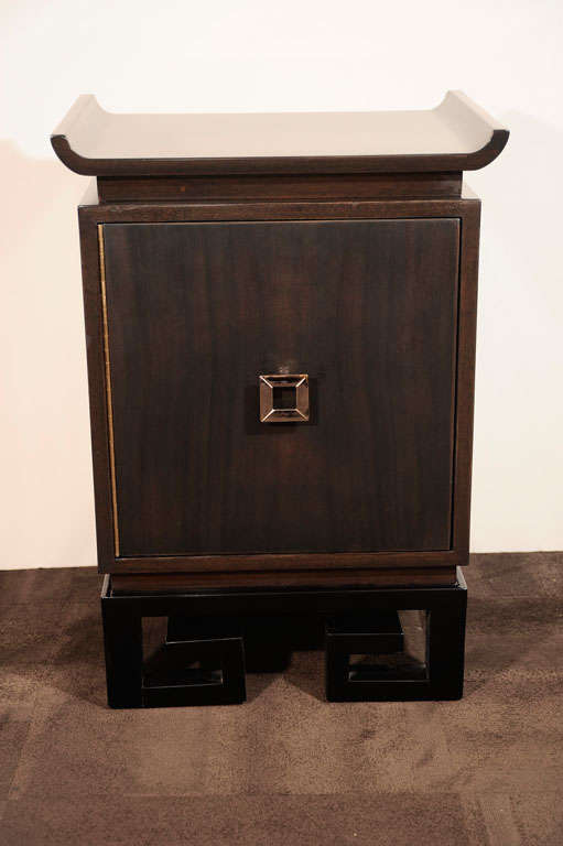 Sophisticated pair of bed side/<br />
end tables with pagoda style tops<br />
and Greek Key detailed bases<br />
in ebonized mahogany  with <br />
modernist antique brass<br />
pulls. Door swing out to <br />
reveal cabinet space with<br