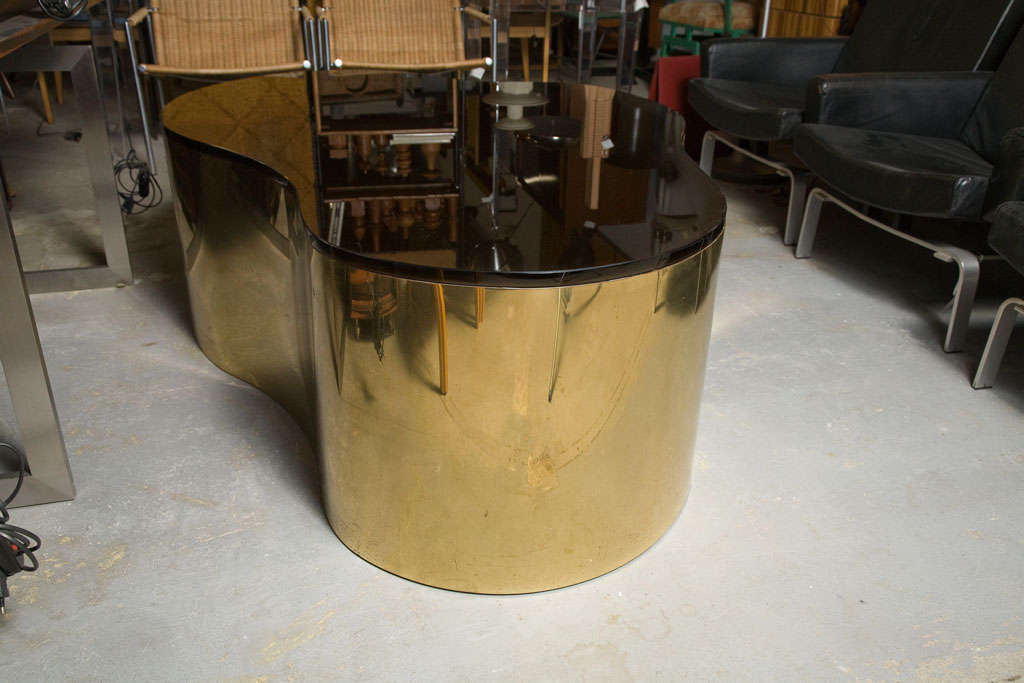 Irregular shaped coffee table by Karl Springer with black glass and brass