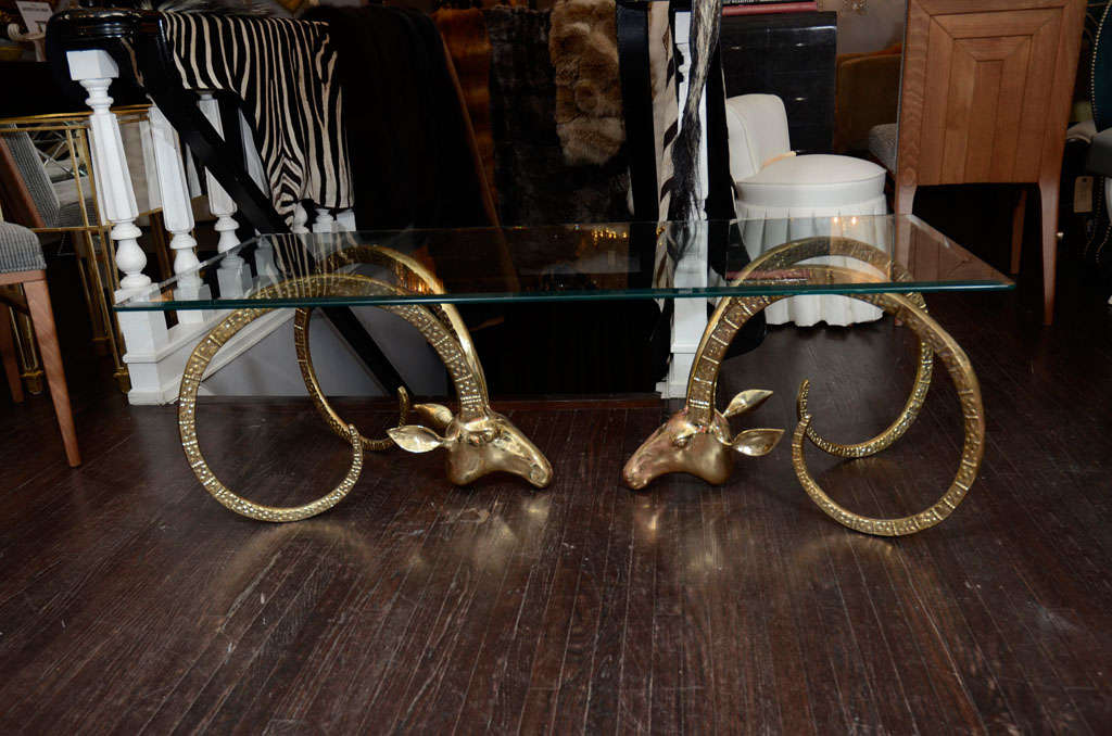 Pair of Brass Ram's head coctail table base with rectangular glass top