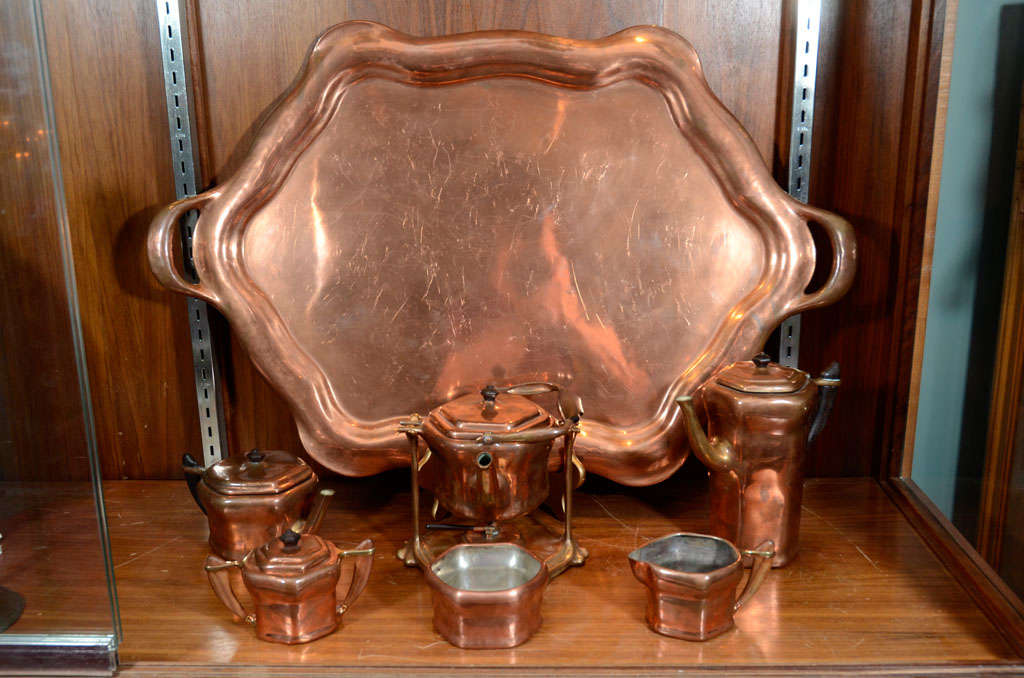 Tiffany Studios six piece copper and bronze Tea - Coffee Service with each 

each stamped Tiffany Studios, New York; including: kettle on stand, height: 10 1/2 inches; coffee pot, tea pot, creamer, covered sugar, and 2 handled tray, length of