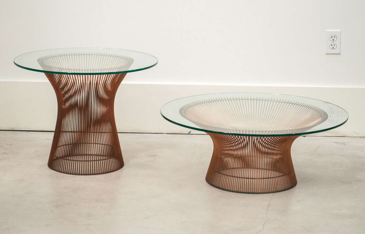 An extremely rare copper cocktail and side table by Warren Platner. Features a round glass top and circular base of concave lengths of copper. 

Dimensions
Low Table : height 11