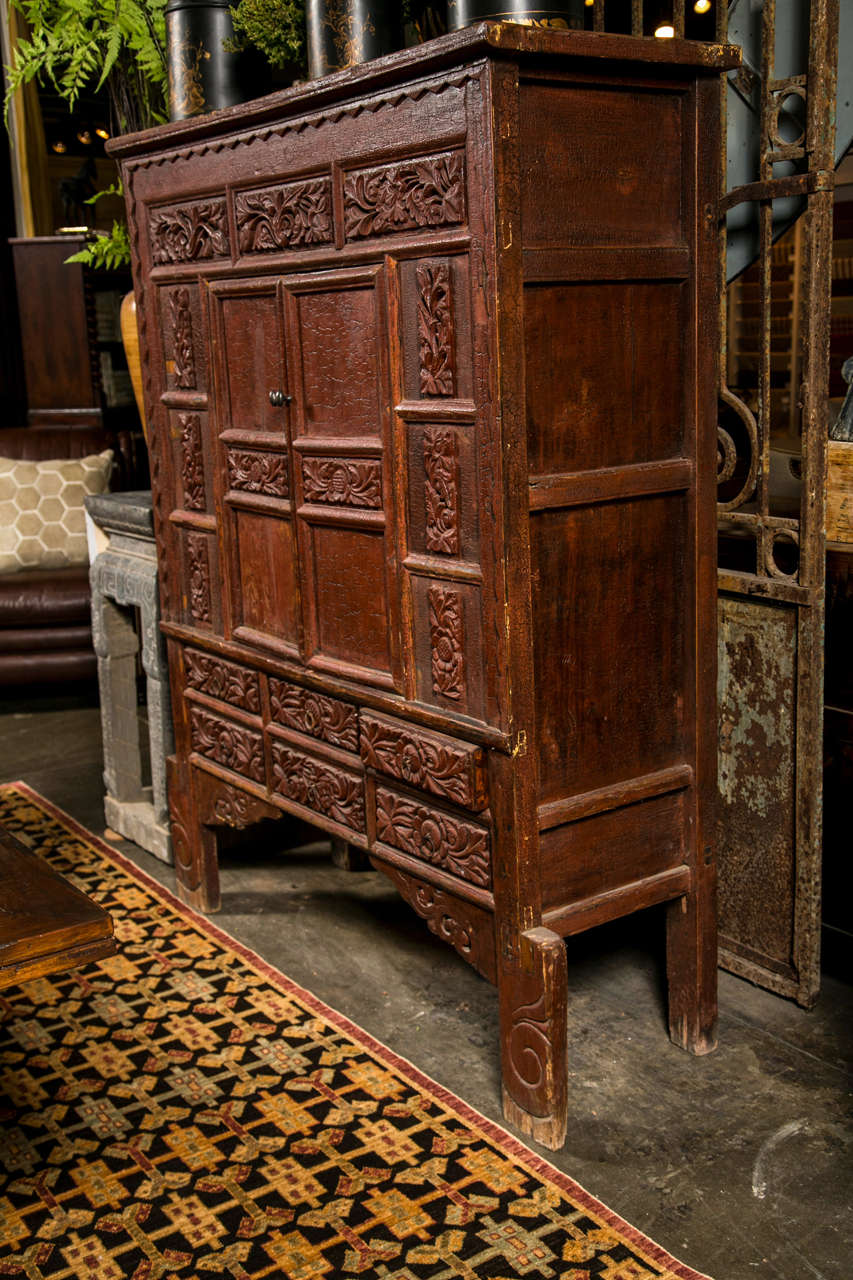 19th c. Shanxi region lacquered cabinet, c. 1850-80 in old red/brown lacquer, now worn to a warm patina, with floral carved panels and drawer fronts