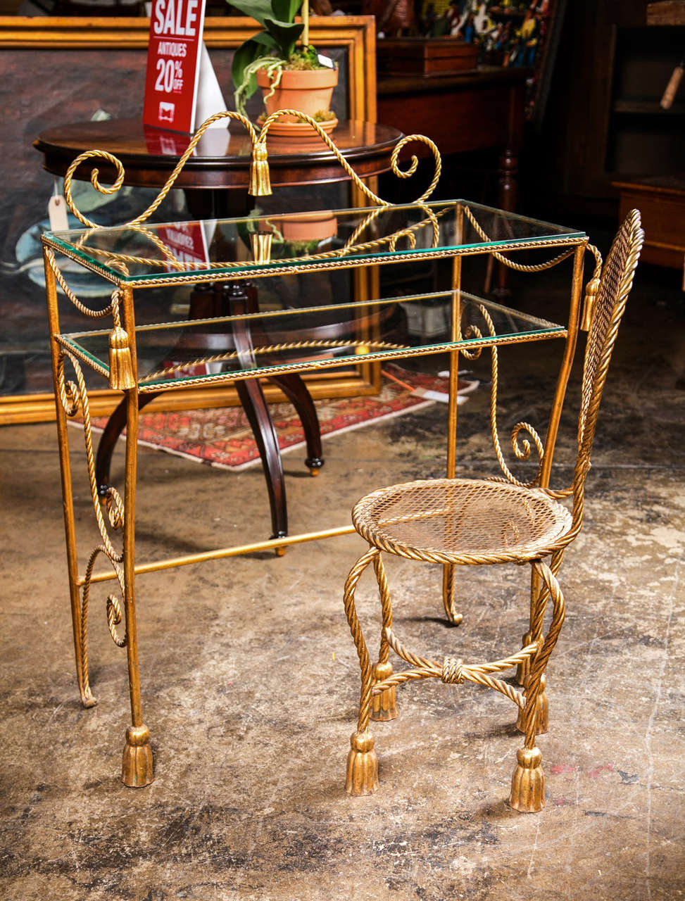 Mid-century gilded iron vanity table and chair, c. 1940-60, of rope twist form with tassel feet and decoration and a heart shaped chair back. The chair dimensions are 13 x 13 x 31 with a  15
