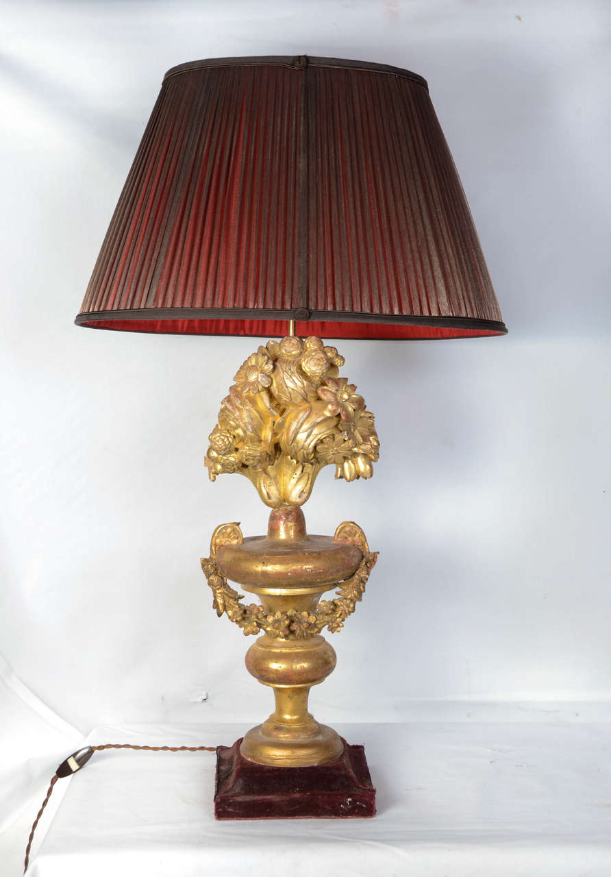 Two giltwood lamps made with 18th century elements, in the shape of bunches of flowers, original gilt, epoque, the shades are new and precious.