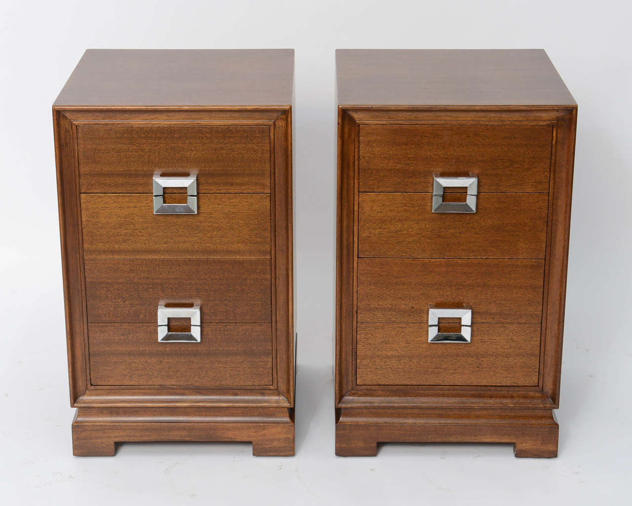 A pair of 1940s Paul Frankl style mahogany nightstands providing great storage by the noted Red Lion Table Co. of Red Lion, PA. Polished nickel handles and strong, yet simple lines rule.  Founded in 1907 Red Lion produced pieces of exceptional