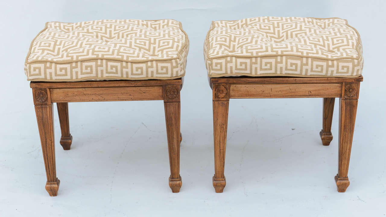 Pair of stools, each having an attached, tufted boxed cushion, set upon fruitwood frame, with slightly bowed apron, raised on rosette-headed, tapering square-section legs with touipe feet.

Stock ID: D8561