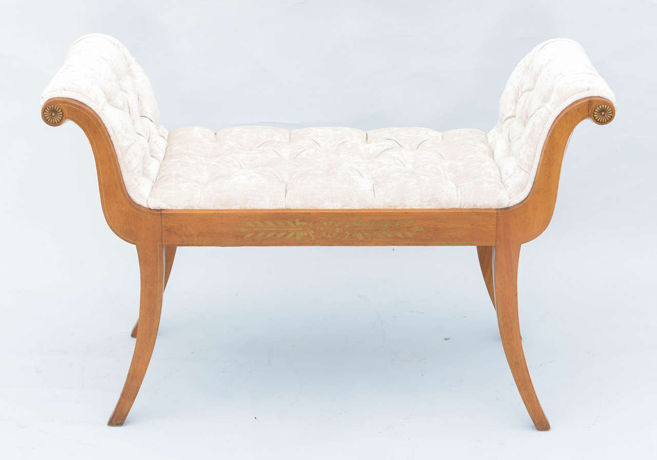 Very attractive roll arm window seat bench, of satinwood, with crushed velvet tufted seat and arms, its apron painted with rosette and laureling, raised on square splayed legs.

Stock ID: D6816