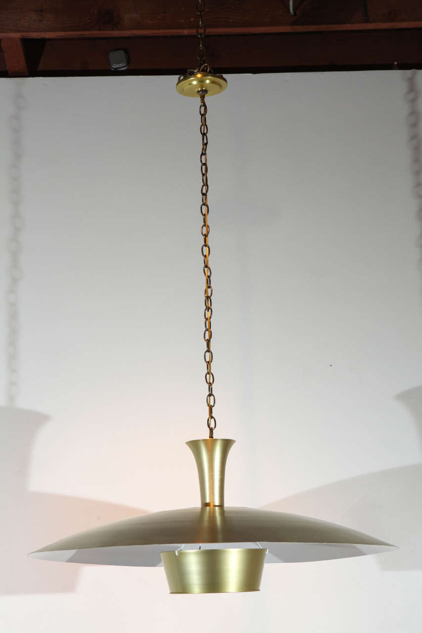 Spun aluminum fixture with anodized brass finish. Newly rewired for a single standard bulb. Ten available.