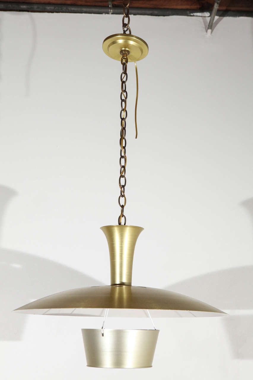 Spun aluminum pendant with anodized brass finish. Newly rewired for a single standard bulb. Eight available.