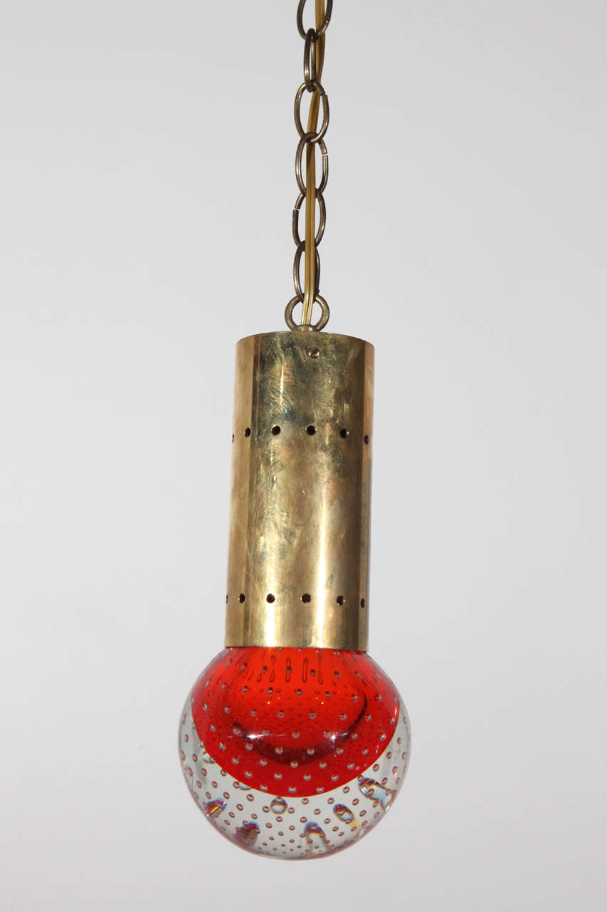 Pendant with blown glass sphere. Sphere contains controlled bubble inclusions. Fixture has a brass chain, and can be wired for either swag or hard-wired installation.