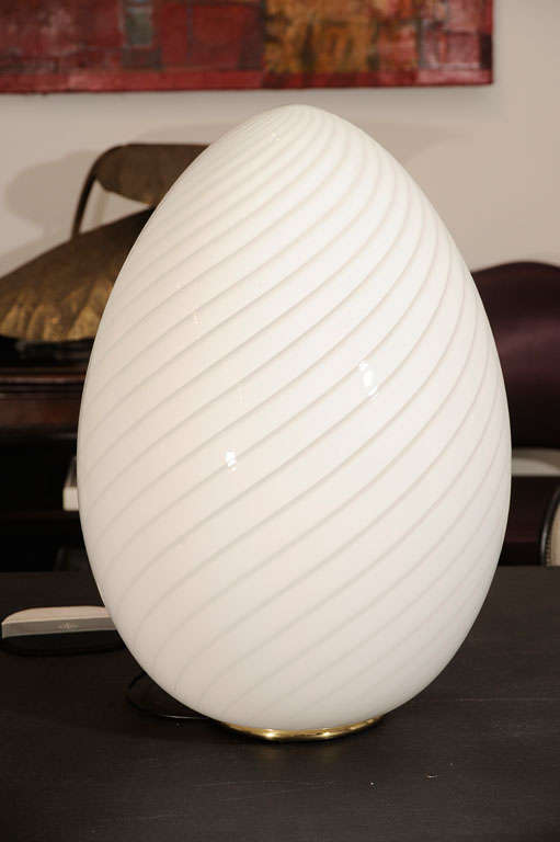 The most delicate of opaque white glass is spiraled with clear geometric wisps creating a beautiful table lamp.