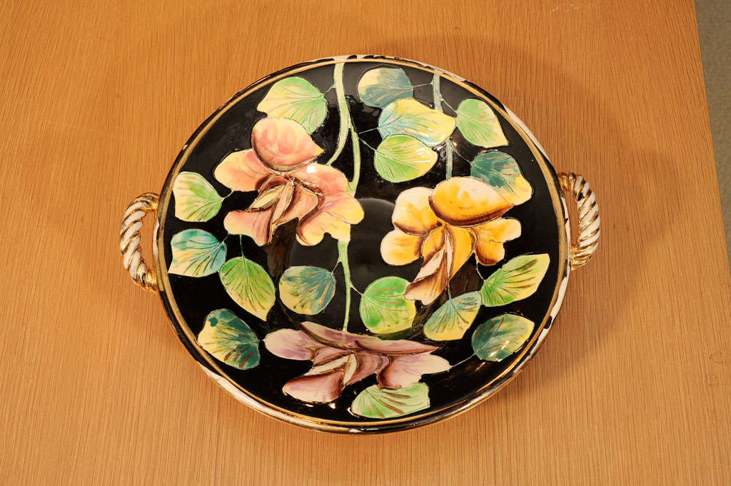 Handmade and hand decorated 2-handle bowl with pastel flowers on black background with goldleaf details.