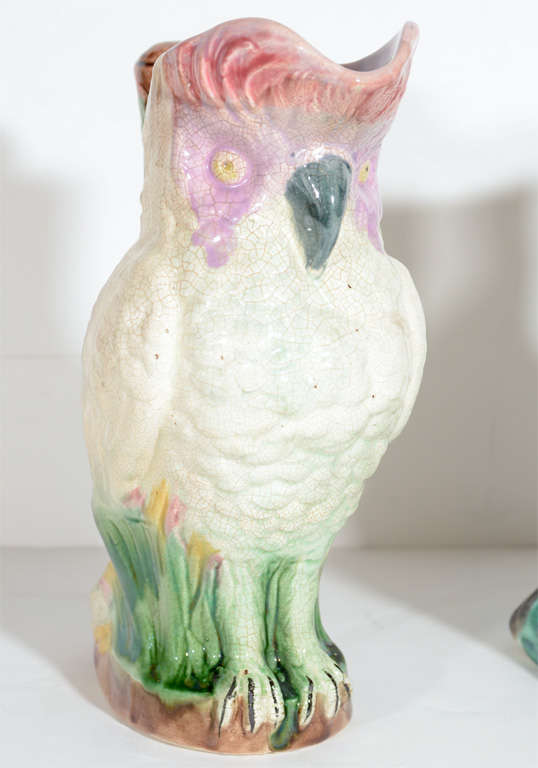 These are a fantastic pair of gorgeous owl and cockatoo pitchers. They represent the best and whimsical elements of Majolica.These are handmade with lush colors and the animals are intertwined with stylized floral and foliage design. The owl pitcher