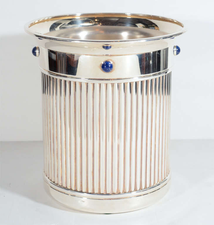This fine Silverplate Art Deco style ice bucket features insets  of lapis Lazuli jewels, includes a liner and the design is in reed form.It is signed Cartier.