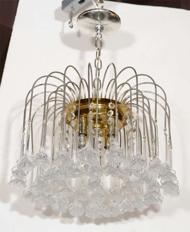 This stunning waterfall design with Chrome and brass fittings was realized, circa 1970, on the fabled Venetian Island of Murano, Italy- renowned for centuries for its superior glass production.  It features an abundance of floral shades attached to