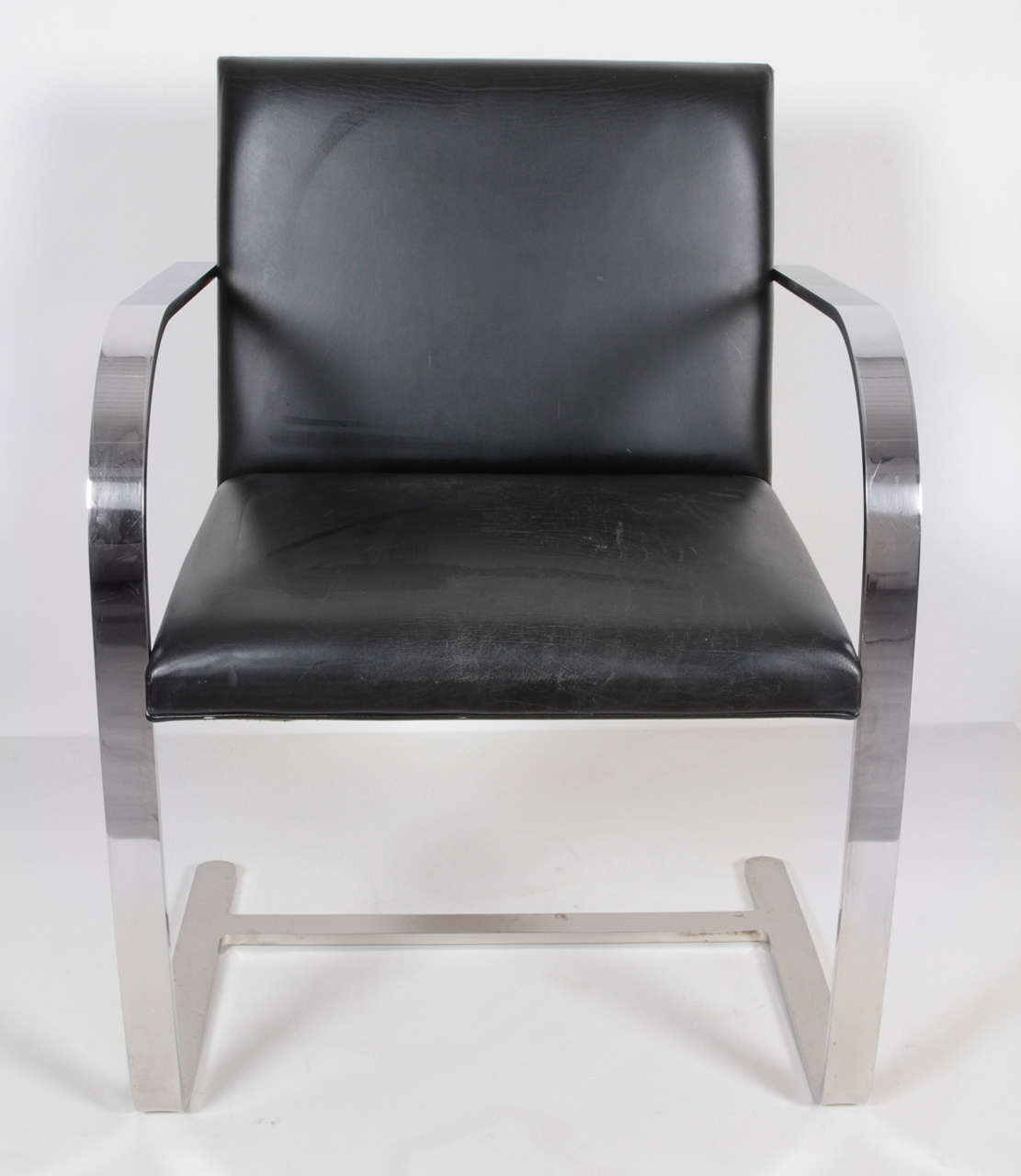 Set of three Mies van der Rohe Brno chairs, 1997.
Modernist cantilever chairs in polished steel with original black leather seat and back.

One chair has original dated label under seat.