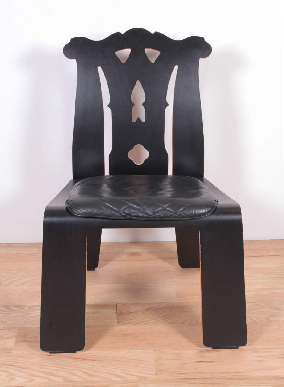 Black laminate plywood, black leather seat. 

Six available.