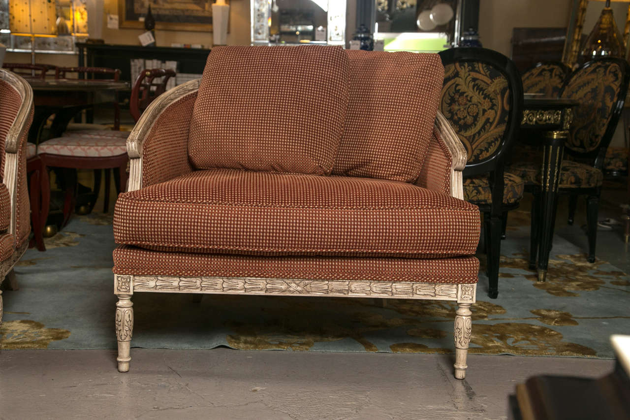 A beautiful pair of Maison Jansen Louis XVI style marquis. This pair is beautifully upholstered with a wonderfully soft rust with cream accented fabric. The wide seat and arched seat back is relaxation at its finest. Two pillows accommodate both for