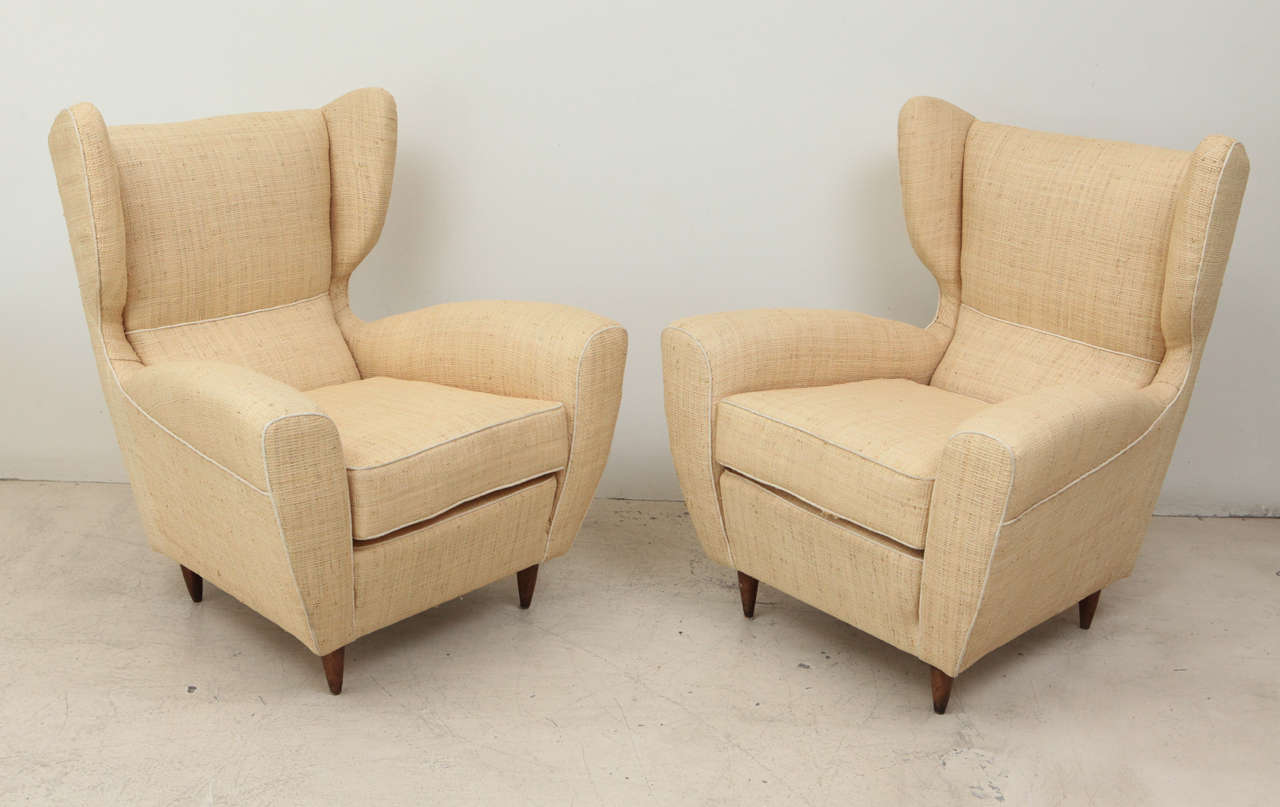 Pair of Raffia Upholstered Mid-Century Italian Wing Chairs .