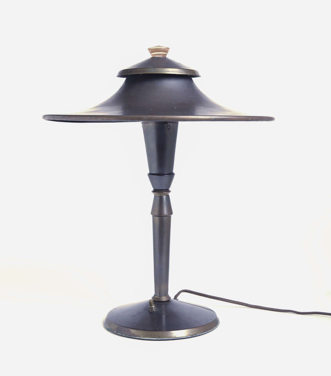 Here is the original large-shade PATENTED version of this now iconic (yet still misattributed) table lamp designed by Leroy Doane in 1928.
Original bronzed-brass finish with peach hued cased-glass finial.

This lamp is designed by neither Von
