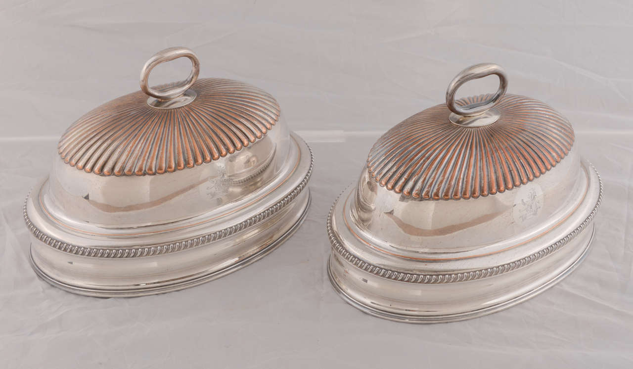 Pair of English silver domes: 19th century silver plate over copper, engraved with heraldic lions and stunning patina from decades of loving use.