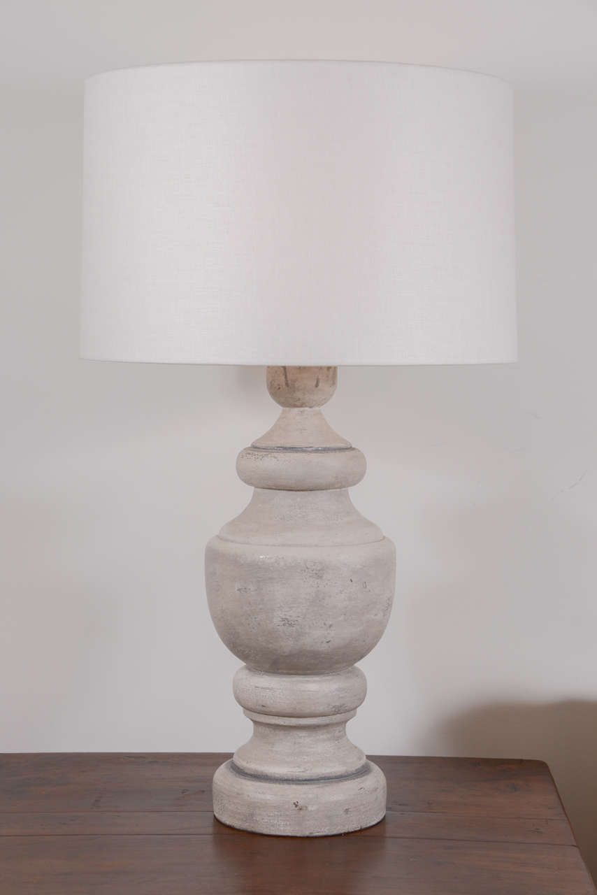 Pair of custom table lamps from large vintage cast finials, with blue-gray painted finish over remnants of silvergilt, and newly wired with linen shades.