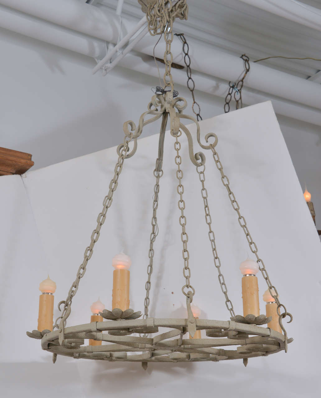 Pale green painted round iron chandelier with scrolled iron gatherer and decoration, painted in a grayish green-blue and newly wired for use within the USA with eight-light.