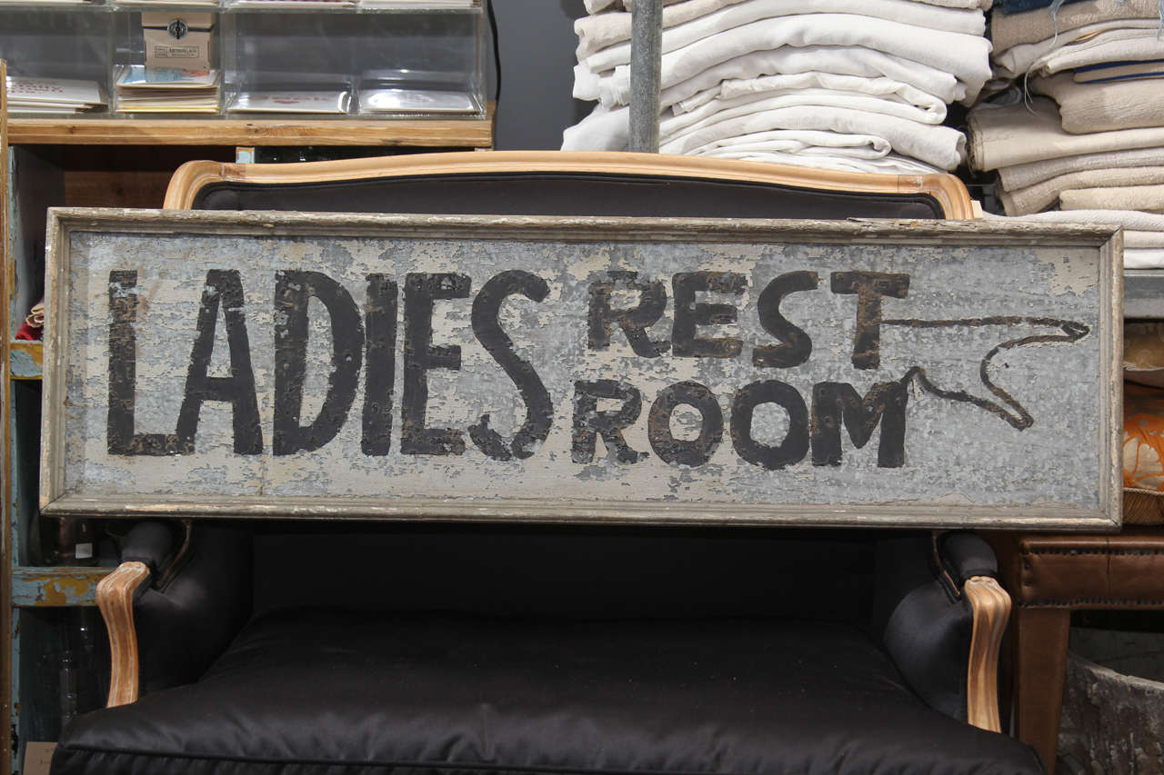 Hand-painted ladies room sign on tin with wood frame.