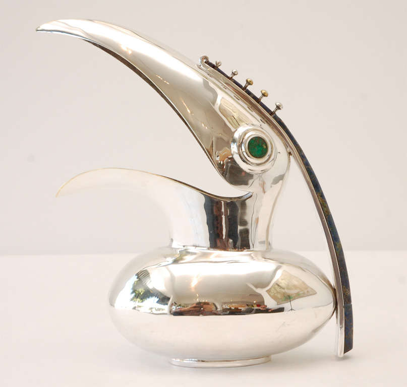 A charming silver plate toucan pitcher with lapis lazuli and green turquoise inlay.