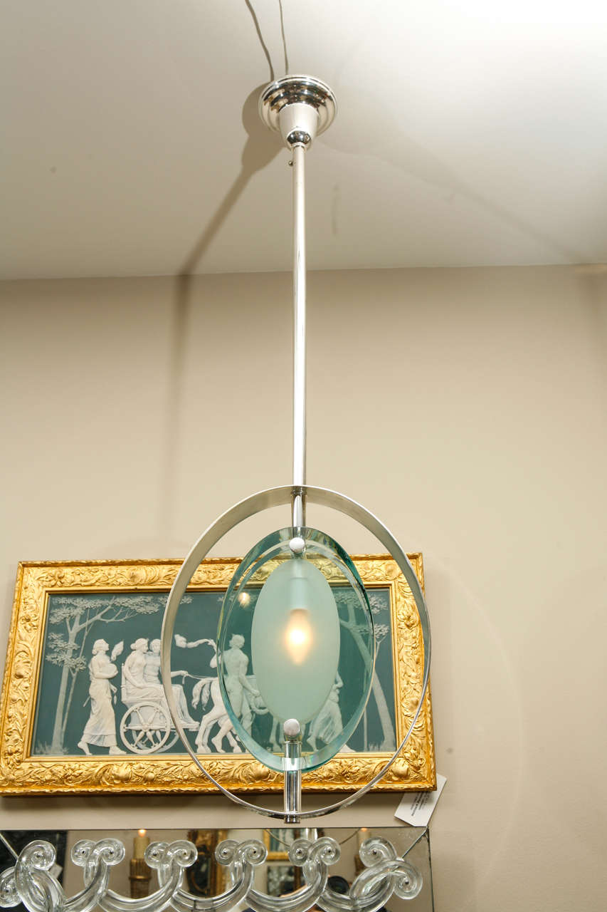 Single light set within a  beautiful frosted glass that has a unique bevel and has a single Candelabra socket .Surrounded by a silver plated surround and suspended on a silver plated rod and ceiling cap . This will require special packing for safe