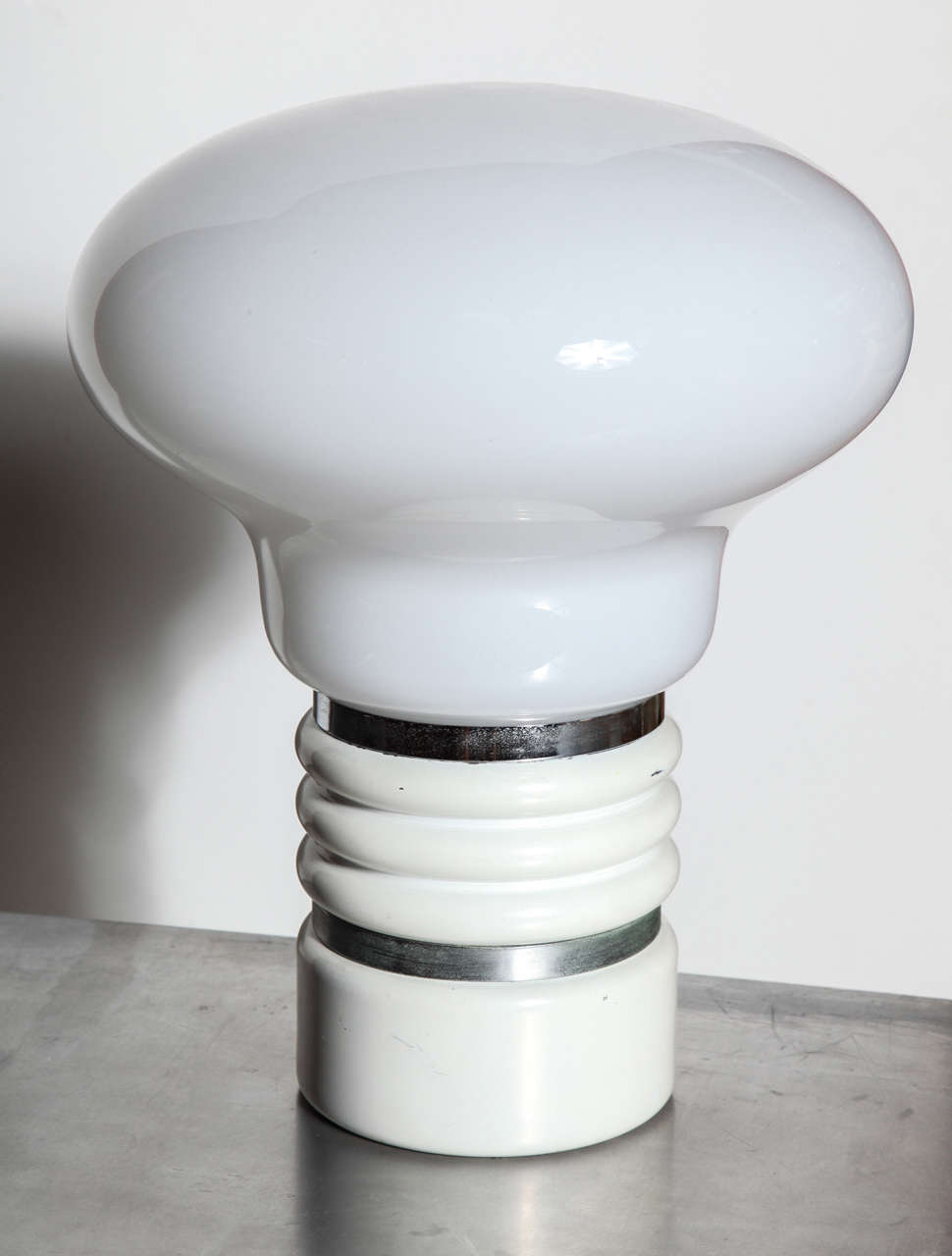 European Modern Pop Art Chrome and Glass Mazzega Murano style Table Lamp.  Featuring a large  hand blown translucent mushroom-shaped 14D White glass light bulb Shade on a banded Chrome and ribbed Off White 6D base. Resembles oversize light bulb.