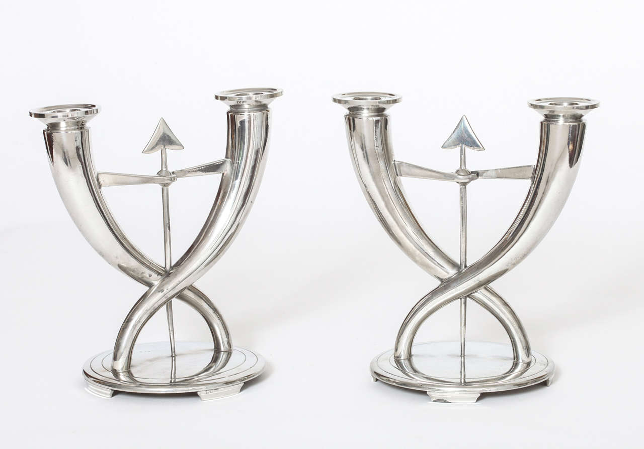 A Pair of Art Deco Candlesticks designed by Gio Ponti for Christofle, c. 1931.

Marks: each impressed 170 and     C in a Square with Two Crossed  Arrows