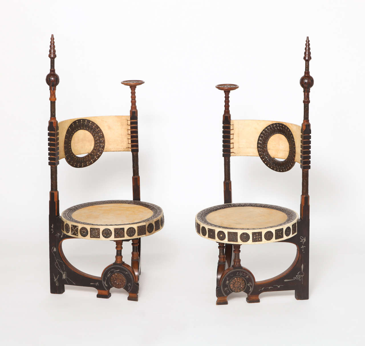 An Opposing pair of Carlo Bugatti Chairs, Wood, Pewter,Copper
and Parchment, one chair signed Bugatti, Milano, c.1898. The Chairs are in Mint condition.