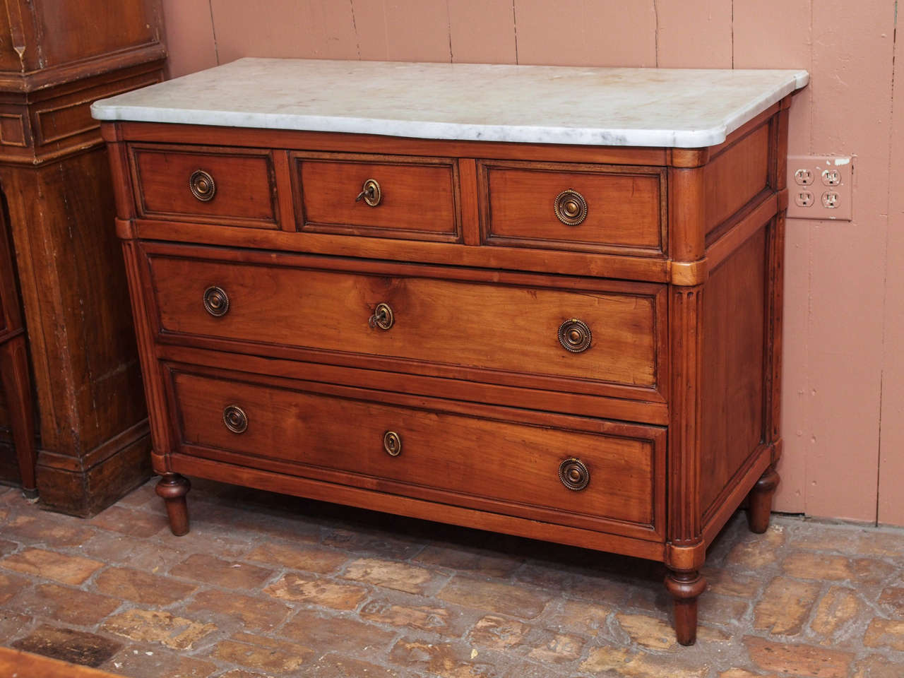 Late 18th century French Directoire period walnut three-drawer commode with white marble top, circa 1790