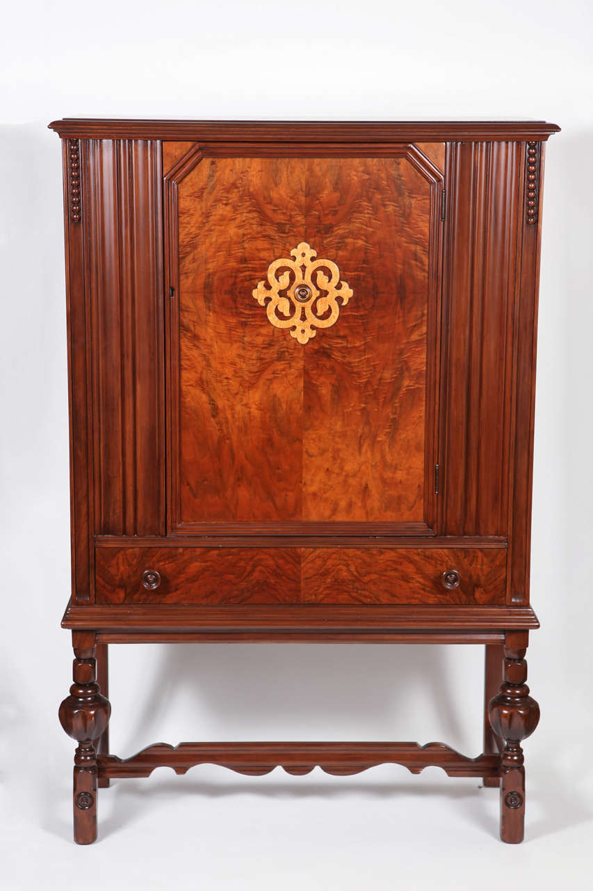 Berkey and Gay walnut storage cabinet with  walnut front panel/door  and birds eye maple overlay motif.