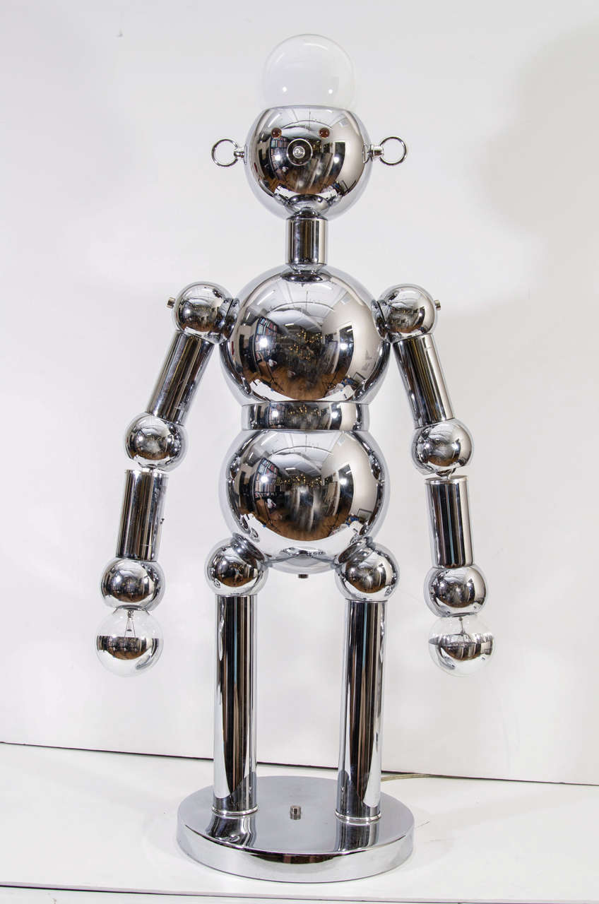 A vintage Torino chrome lamp in the shape of a robot with movable arms and eyes that light up orange.

Reduced from: $7500