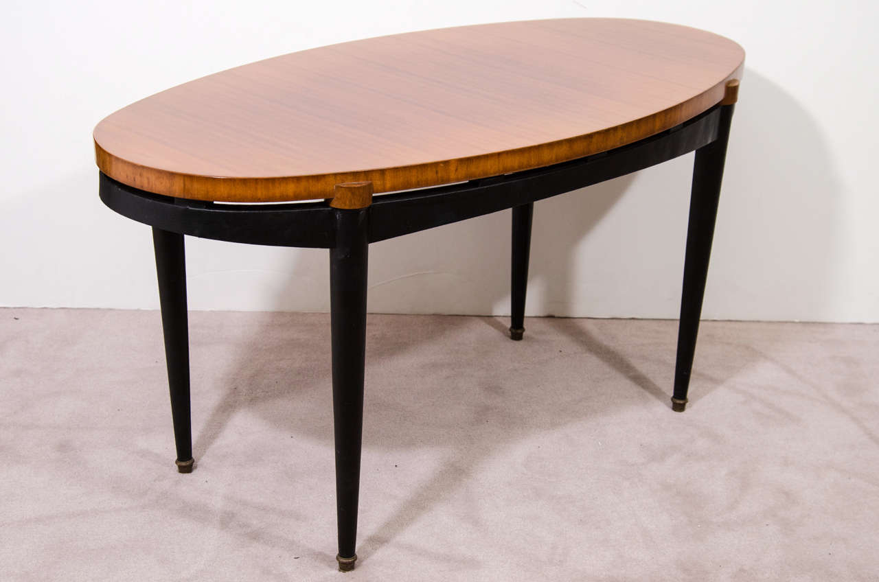 A vintage French coffee or cocktail table with an oval cherry wood surface and black faux leather wrapped legs. The piece is similar to those designed by Pierre Guariche

Reduced from: 1,950