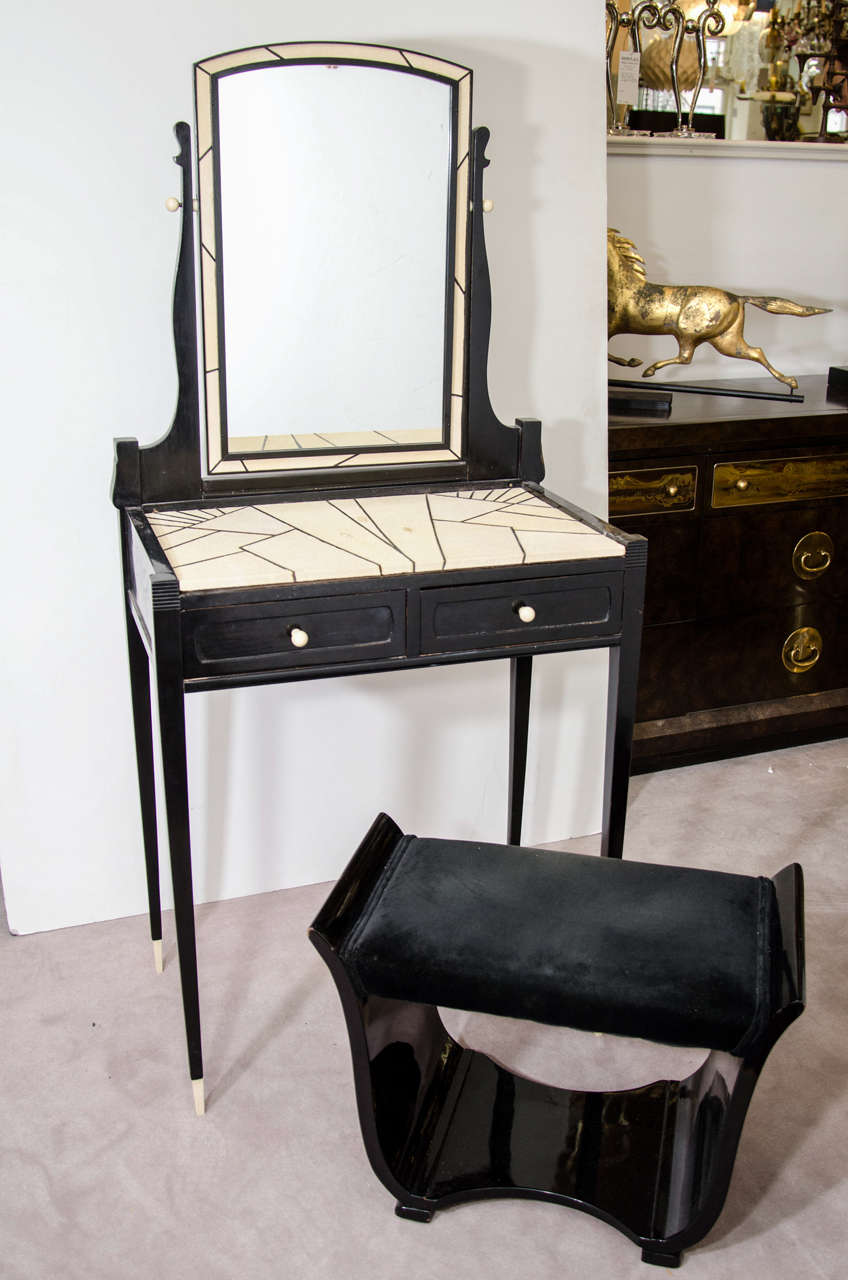 An Incredible Art Deco Maurice Dufrene vanity with white shagreen surface, Black lacquered frame and celluloid accents. The Matching Bench is black lacquered with Black Velvet Upholstery. Amazing Geometric Design on the Top  Shagreen Surface of this