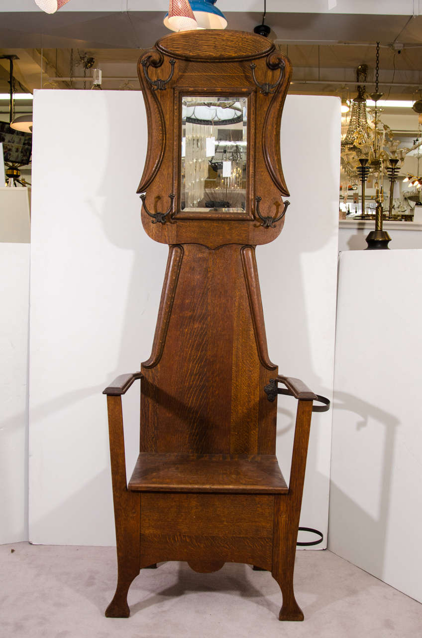 A Victorian oak Hall Tree with hooks for hanging coats, a mirror, umbrella, or cane holder.  The seat lifts up and provides a storage area.

Reduced from: $1,125