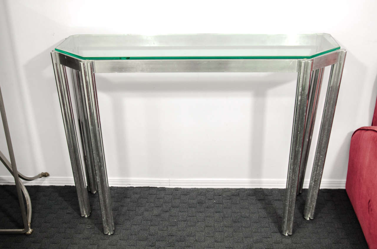 A vintage, highly modern Italian console table, produced circa 1970s by Alessandro Albrizzi, with glass top on chrome frame and six-legged base. Good condition with age appropriate wear; some scratches and a chip in the glass.