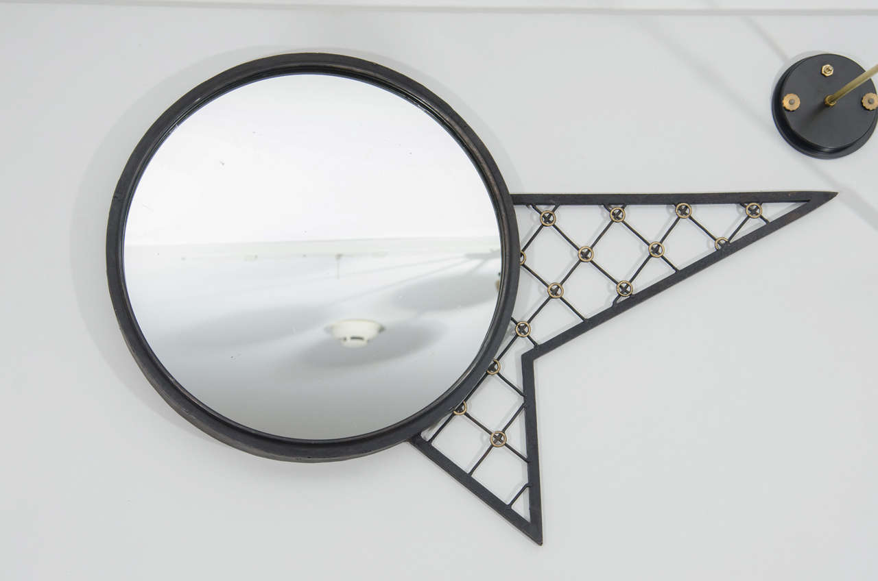 Whimsical mirror with iron grids and gilt rings reminiscent of the work by Jean Royere. Original condition and glass. Matching console sold separately.