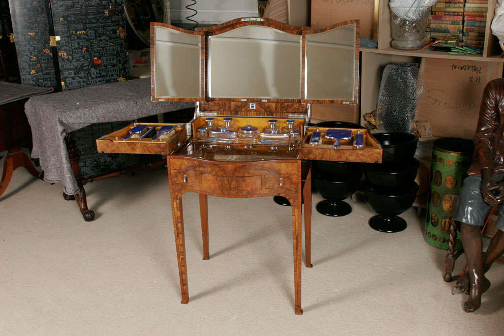 A superb Art Deco Dressing Table by Mappin and Webb.<br />
The case veneered with the finest Burr Walnut veneers with feather banding and ebony stringing. The shaped front with two side drawers and a central “Secret “ drawer.<br />
On square