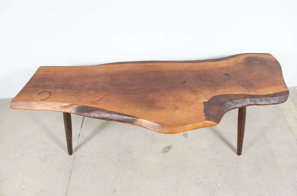 A beautiful American Studio Craft coffee table with a free edge slab of walnut supported on four turned legs. Signed to the underside. By Roy Sheldon, Marlboro, VT. U.S.A., 1969.