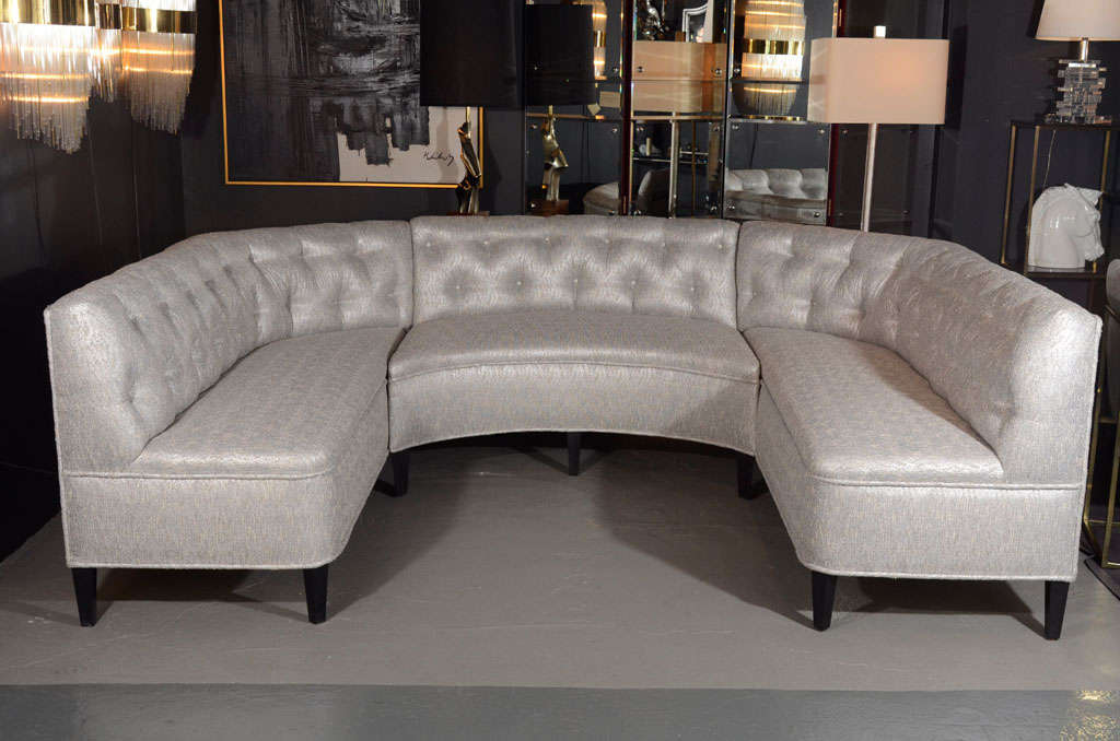 Gorgeous 1940's Hollywood sectional sofa with button back and tufted details. Newly upholstered in a metallic grey and ivory boucle fabric with woven platinum fibers and with ebonized walnut legs. The sofa has an unusual and sophisticatd 